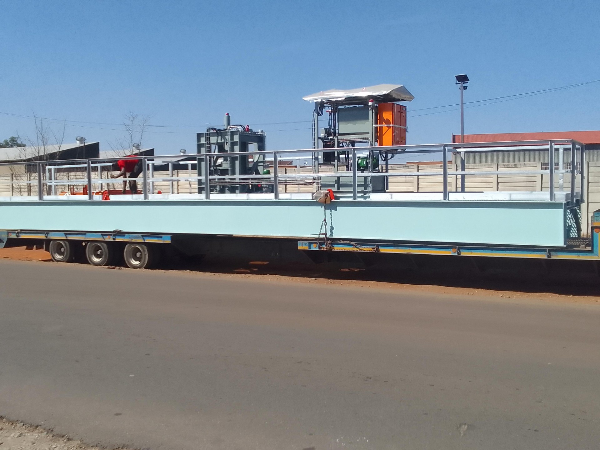Thickener bridge structure with drive assembly and walkway loaded on a transport trailer